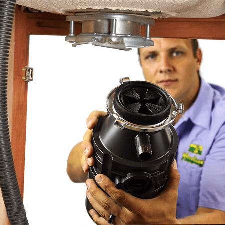 Plumber Holding Garbage Disposal