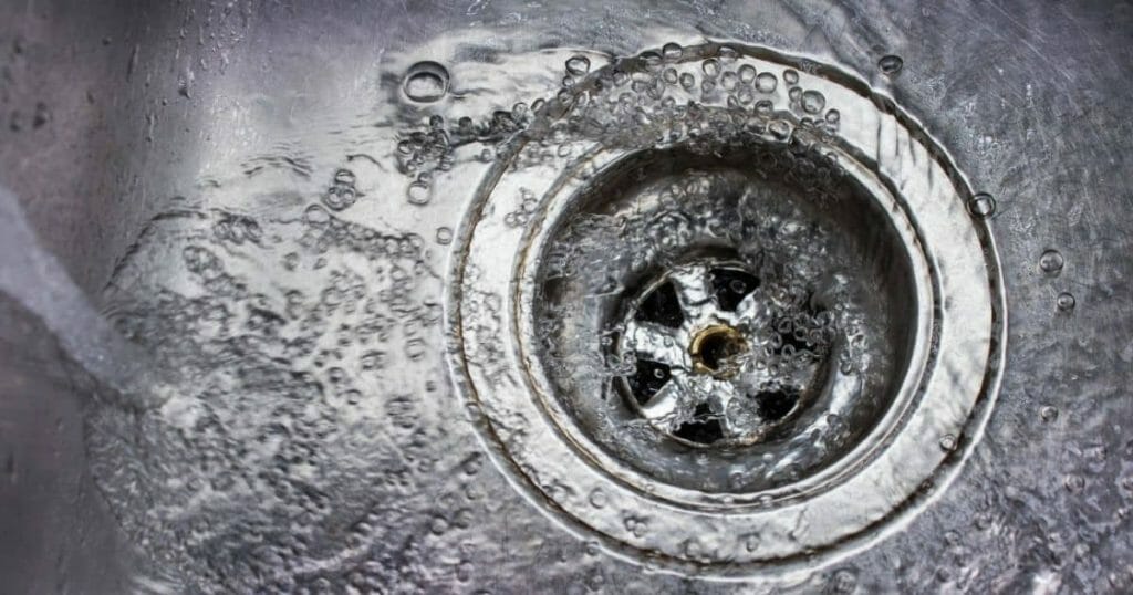 Water running down a metal drain.